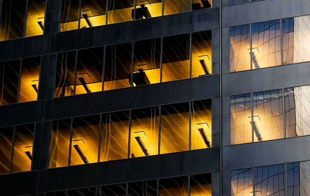 A building with many windows lit up at night.