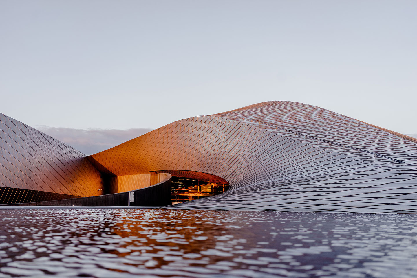 A boat is floating on the water near some waves.